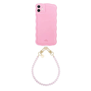 Glossy wavy dusty pink iPhone 11 case with a short beaded wrist strap.