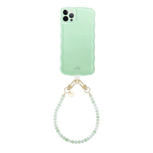 Glossy wavy sage sorbet iPhone 12 Pro case with a short dusty green beaded cord and gold clasps.