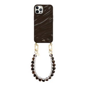 Glanzende diepbruine iPhone 12 Pro hoes met Sweetheart Brown en wit parelkoord, bevestigd met gouden haakjes.