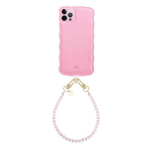 Glossy wavy iPhone 12 Pro case in bubble blush pink with a short dusty pink beaded cord.