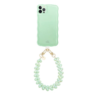 Glossy wavy sage green iPhone 12 Pro case with a detachable Funky Hearts cord.