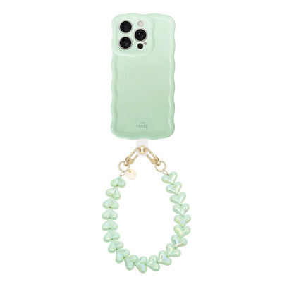 Glossy wavy sage green phone case with a pearl-like Funky Hearts cord and gold hardware.