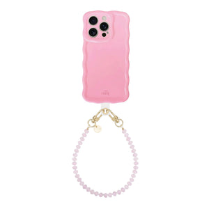 Glossy wavy bubble blush iPhone 13 Pro case with a short dusty pink beaded wrist cord.