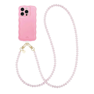Glossy wavy light pink phone case with a long dusty pink beaded cord and gold hardware.