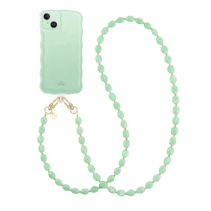 Glossy wavy iPhone 13 case in sage green with a long ocean mint beaded cord.