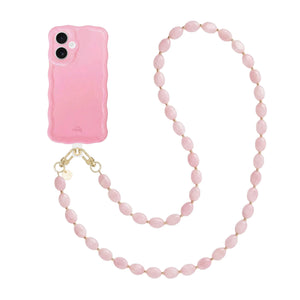 Glanzend roze iPhone 17 hoesje met golvende vorm en lang Ocean koord van roze kralen.
