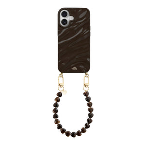 iPhone 16 Glaze Cord Case in Sweetheart Brown with a short heart-beaded wrist strap and gold hardware.