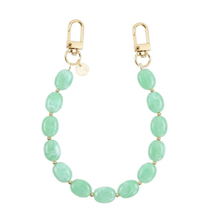 Kort Ocean Mint polskoord met mintgroene kralen en gouden sluitingen.